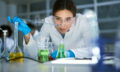 Female chemist working on medical research in laboratory.