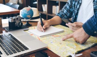 Travelling concept.Two men choosing place of vacation, exploring