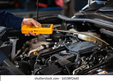 mechanic-hand-check-leaks-gas-260nw-1653892660
