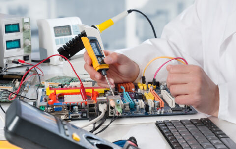 Repairman fixes electronic equipment